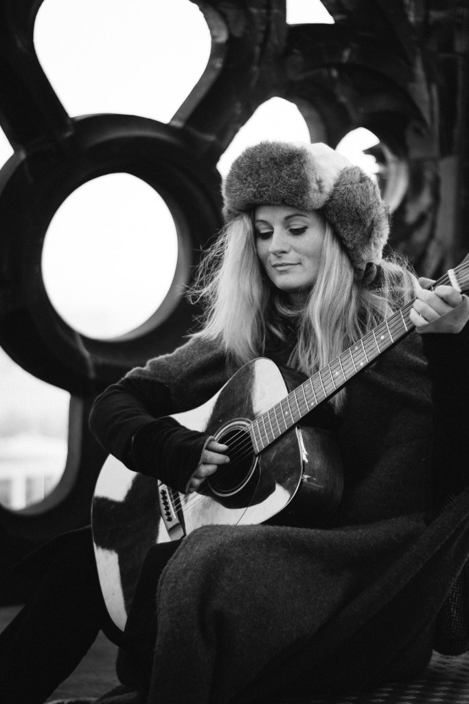 Marta Latour in schwarzweiß mit Gitarre